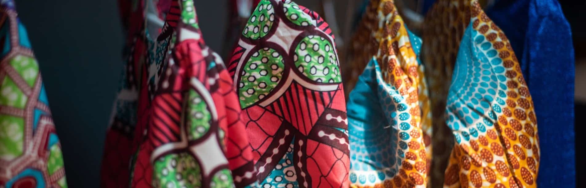 Close up shot of colorful african dresses hanging on rack